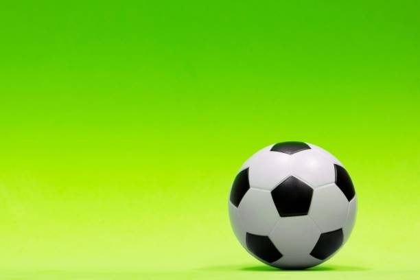 istock Soccer ball isolated against a plain green background. 1269481760
