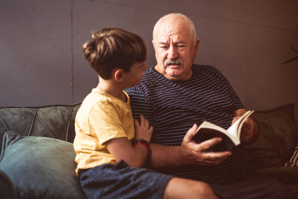 istock Grandfather reading with his grandson 1269481971