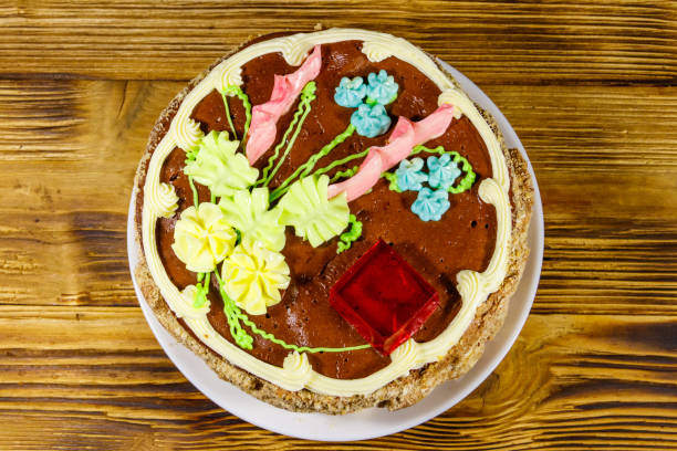 Kiev cake with cream, nuts and meringue on wooden table. Top view