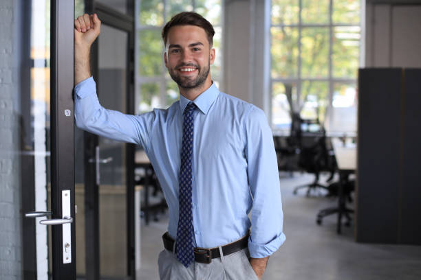istock Young handsome businessman smiling in an office environment 1269485068