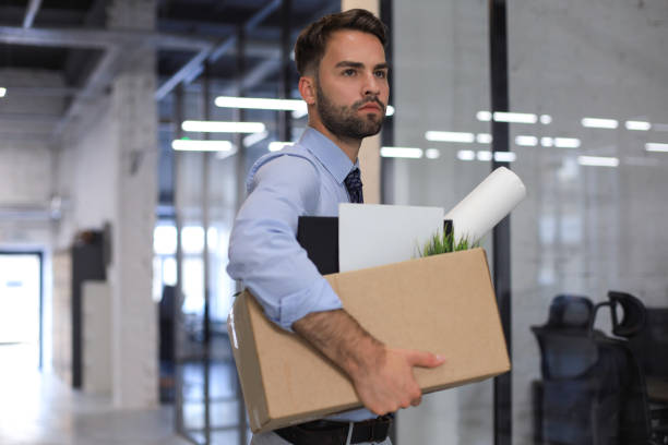 istock Sad dismissed worker is taking his office supplies with him from office. 1269485242