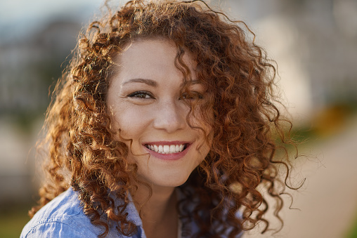 Close-up portrait of smiling female. Woman entrepreneur looking at camera and smiling