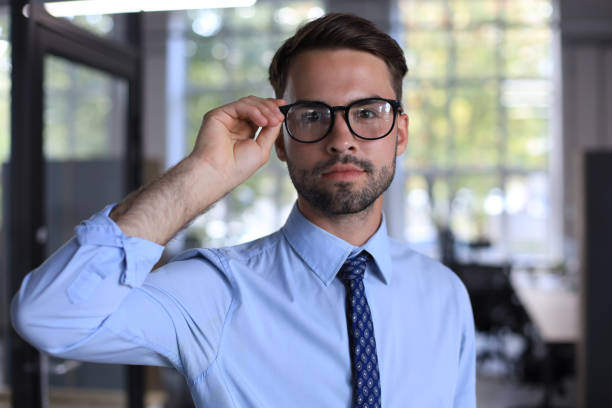 istock Young handsome businessman smiling in an office environment 1269485456