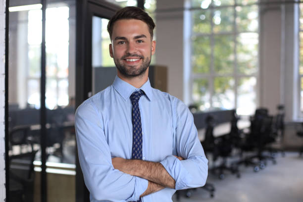 istock Young handsome businessman smiling in an office environment 1269486149