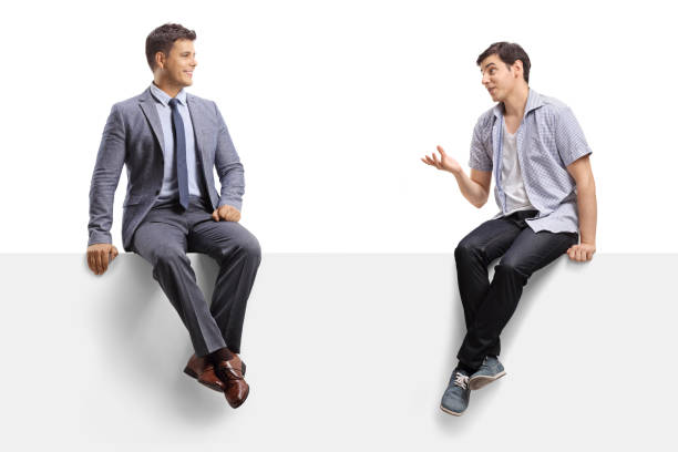 istock Casual guy talking to a man in a suit and tie and sitting on a panel 1269487631
