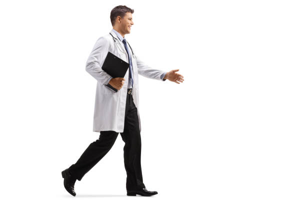 istock Young male doctor walking and greeting with hand 1269488825
