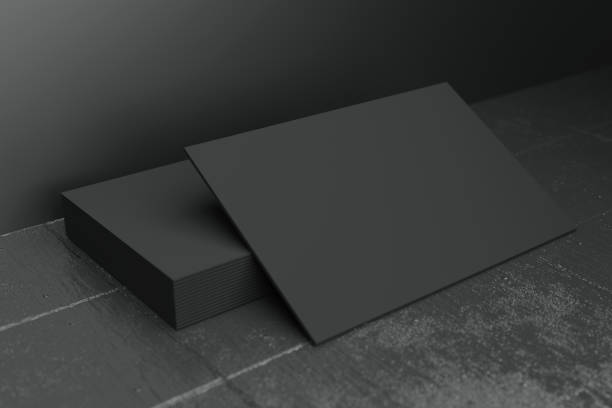 istock Black horizontal business card paper mockup template with blank space cover for insert company logo or personal identity on black concrete floor background. Modern concept. 3D illustration render 1269493695