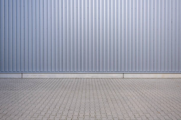 Floor of concrete stone and wall of metal sheet metal as background stock photo