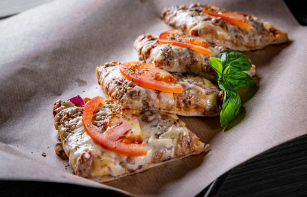 slice of greek pizza with tuna, red onion, cheese, tomato - pizza tuna prepared fish cheese imagens e fotografias de stock