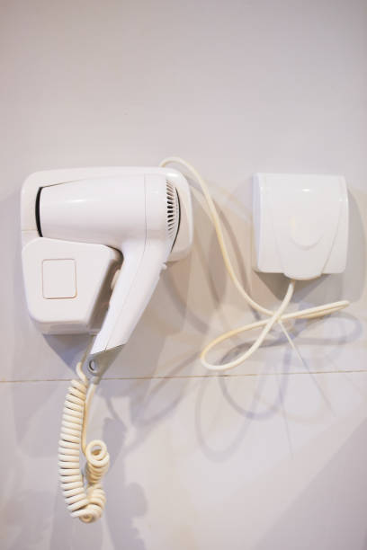 istock The hair dryer hangs on the bathroom wall 1269498029