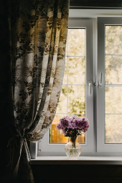 istock Vase with pink flowers on the cottage window. 1269498149