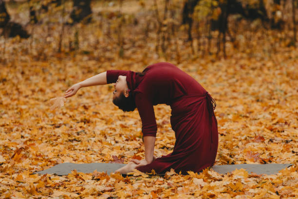 istock Curvy girl doing yoga in nature. 1269498165