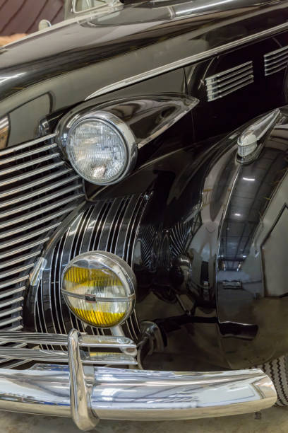 istock Front bumper & headlight on 1940 vintage black car 1269498563