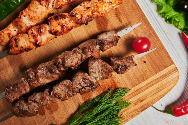 istock lamb shish kebab with vegetables on a wooden Board. 1269498614