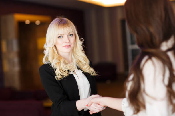 istock Two Businesswomen Shaking Hands In Modern Office. 1269499444