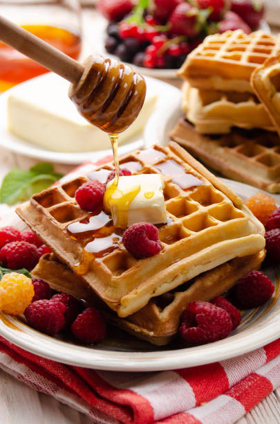 istock Belgian waffles served with butter raspberries and honey 1269499498