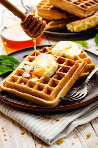 istock Belgian waffles served with butter and honey 1269500072