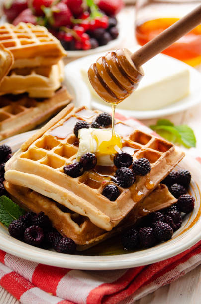 istock Belgian waffles served with blackberries butter and honey 1269500084