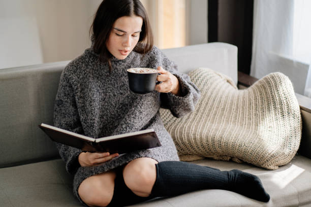 istock Woman enjoy hot chocolate and reading a book 1269501476