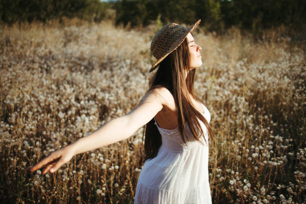 istock Young woman spreading hands enjoying summer nature 1269501545