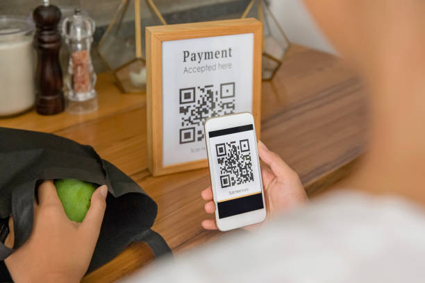 istock Southeast Asian woman using QR code payment in a store 1269502900