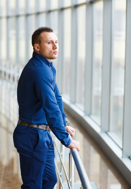 istock Businessman standing near the window and looking into it. 1269503635