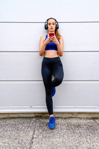 istock Young woman choosing music for exercise 1269506845
