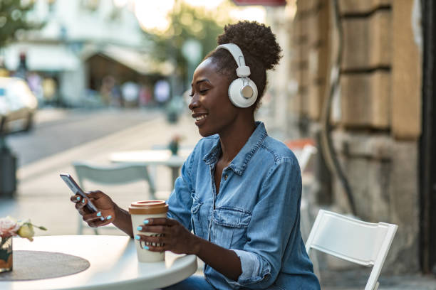 istock Woman using smart phone and enjoying in coffee 1269507069