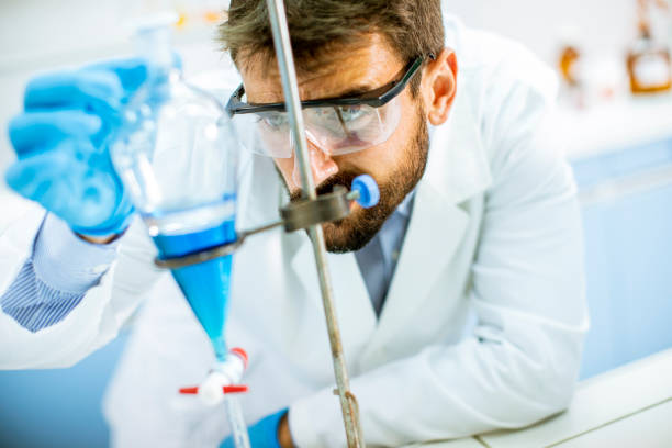 istock Researcher working with blue liquid at separatory funnel 1269508596