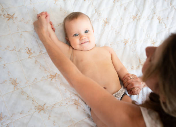 istock Toddler training with mother on bed at home 1269510355