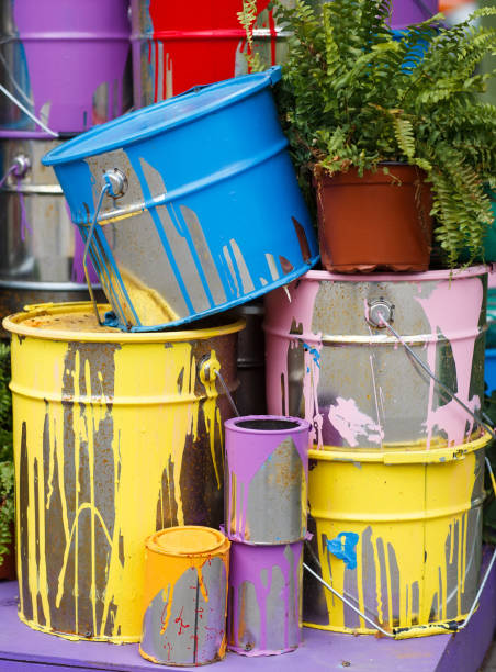 istock The used paint cans. Many multi-colored buckets with traces of paint on them 1269516702