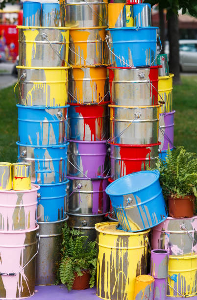 istock The used paint cans. Many multi-colored buckets with traces of paint on them 1269516773