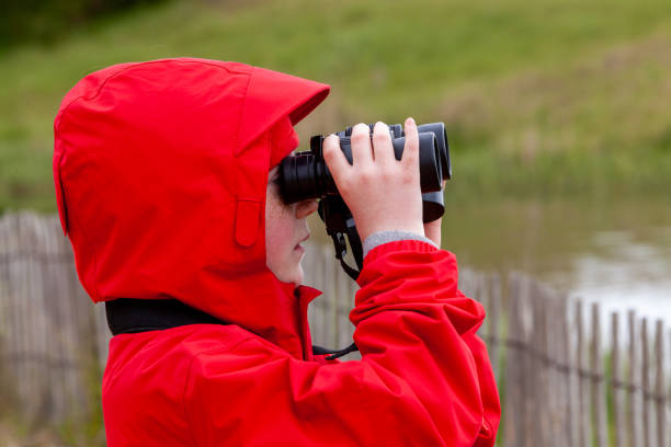 istock Girl dressed in red, watching animals with a binocular 1269516783