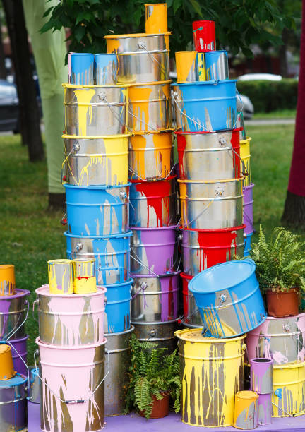 istock The used paint cans. Many multi-colored buckets with traces of paint on them 1269516785