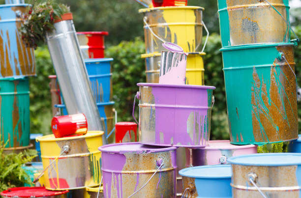 istock The used paint cans. Many multi-colored buckets with traces of paint on them 1269516796