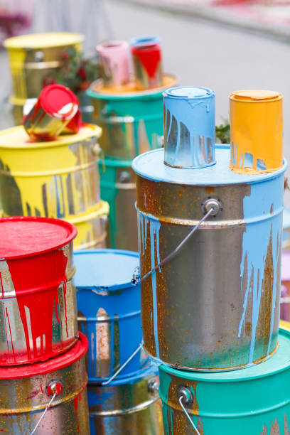 istock The used paint cans. Many multi-colored buckets with traces of paint on them 1269516809