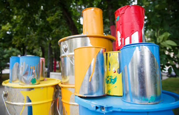 istock The used paint cans. Many multi-colored buckets with traces of paint on them 1269516840