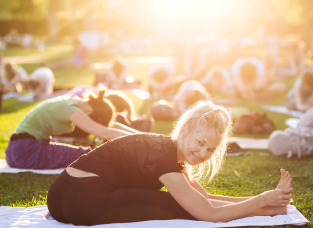 istock Yoga woman on green grass. Big group 1269516920