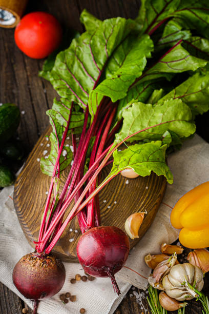 istock whole beets with large leaves, spices and coarse salt, rustic style, cherry tomato branch, on a black background 1269516970