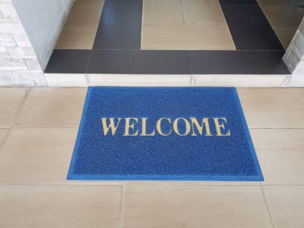 istock welcome text on blue doormat in front of entrance 1269517436
