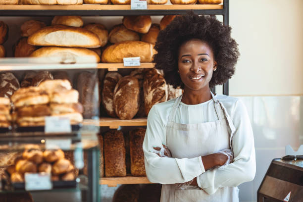 istock Small Bakery shop owner standing in front of store 1269519579