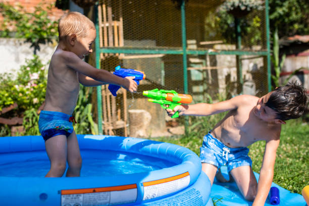 istock Two cute boys having a water gun fight 1269520011
