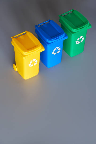 istock Three color coded recycle bins, isometric picture on geometric paper background with copy-space. Recycling sign on the bins, blue, yellow and green. Waste separation to recycle plastic and glass. 1269521858