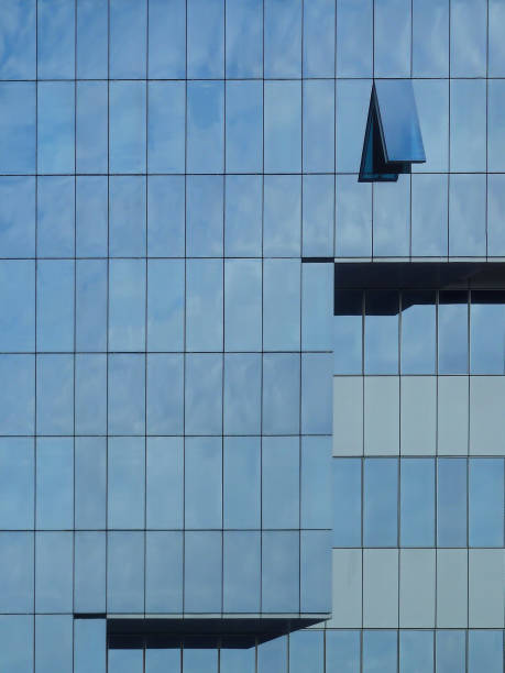 istock Modern building with reflections from the sky and only one opened window 1269522889