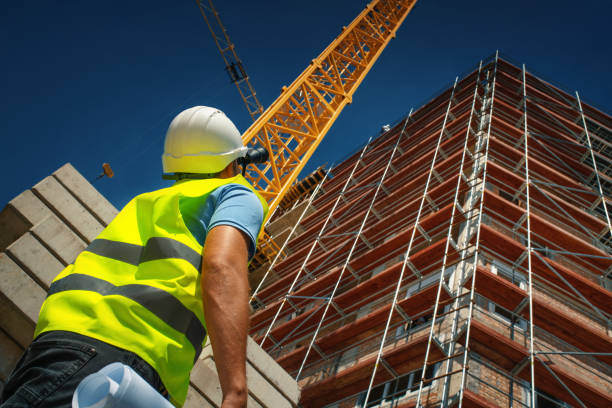 Construction engineer supervising building process stock photo