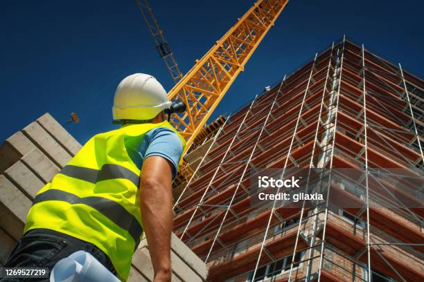 Construction Engineer Supervising Building Process Stock Photo - Download Image Now - Construction Industry, Construction Site, Building - Activity