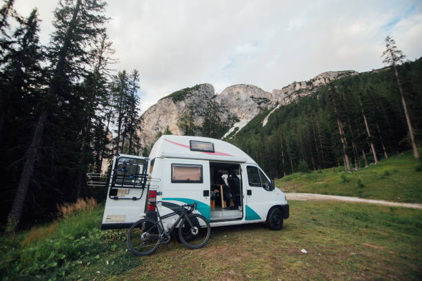 istock Cute camper van RV in wild camping spot in nature 1269528920