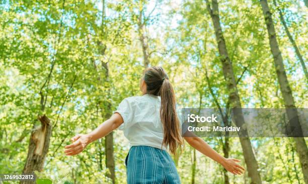 Free Woman Breathing Clean Air In Nature Forest Happy Girl From The Back With Open Arms In Happiness Fresh Outdoor Woods Wellness Healthy Lifestyle Concept Stock Photo - Download Image Now