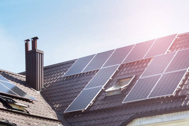 istock Solar energy collection panels on a roof 1269533022