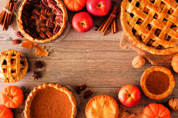 istock Homemade autumn pie frame over a rustic wood background. Apple, pumpkin and pecan. 1269539049